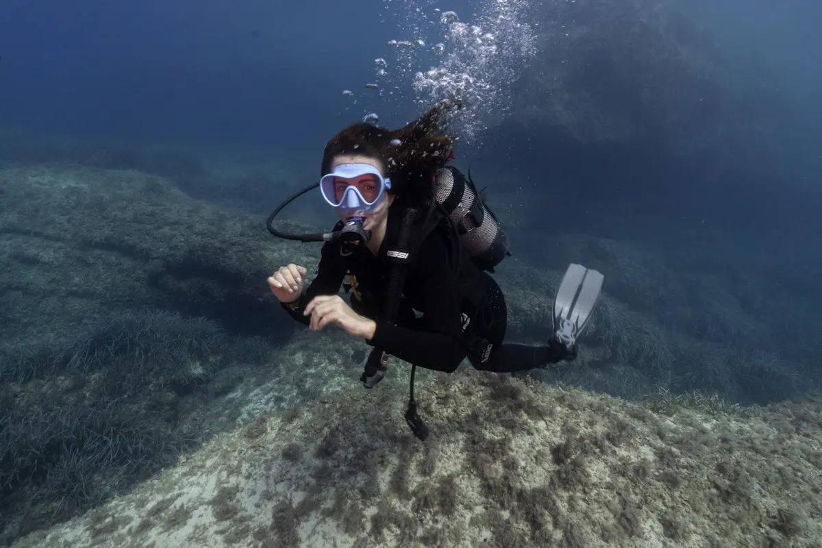 Underwater photo of a woman scuba diving in Formentera