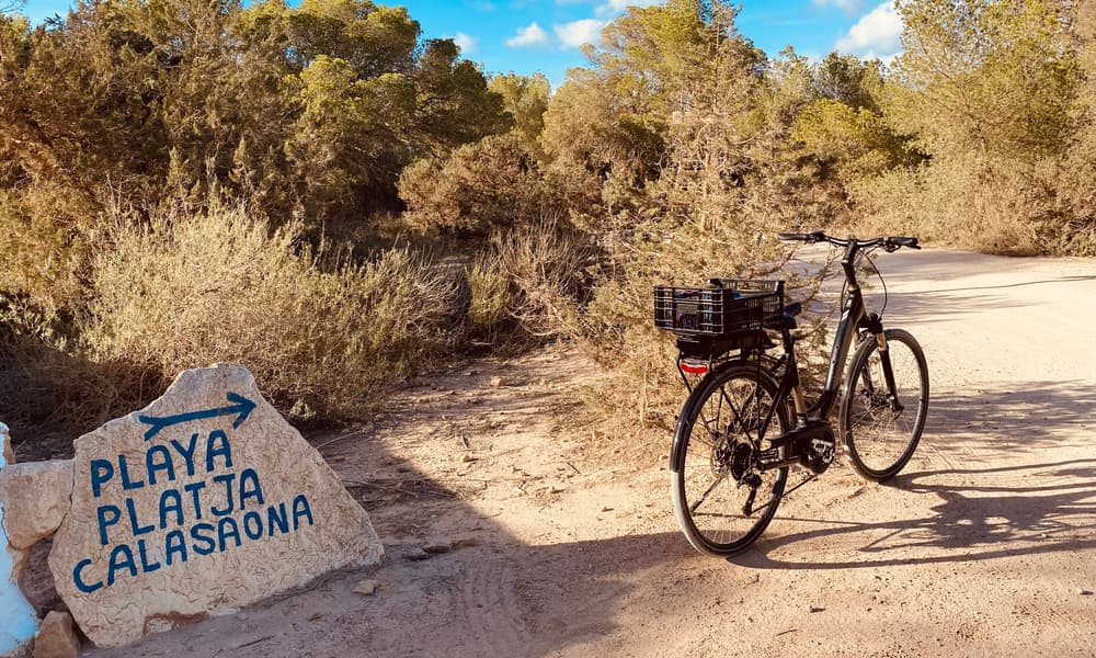 Bicycle on a rural path in Formentera near a sign to Cala Saona